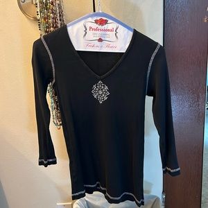 Black long sleeved shirt with decorative design on chest